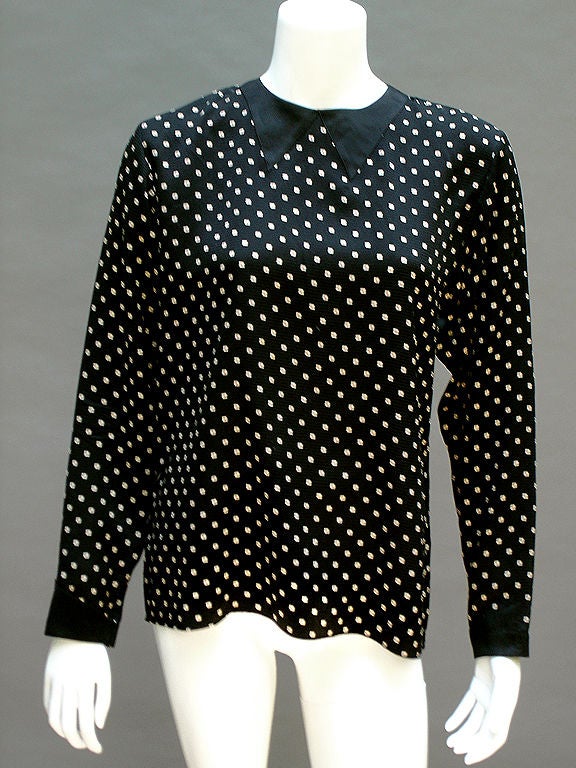 Geoffrey Beene silk mid-80s blouse in jet black with teeny white squares and teeny tiny red dots . . . Very subtle pinstripes, too . . . Best of all is the trompe l'oeil bow tie in silk satin--so cute! Fastens with two loops and buttons at the back