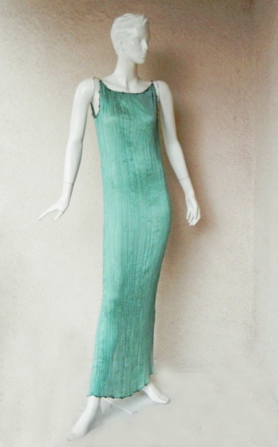 1999 John Galliano, for the House of Dior, designed a homage to Mariano Fortuny. This Delphos gown fashioned of accordian pleated teal china silk in the fashion of the original Fortuny Delphos. Glass beads trimmed at neckline, armholes, and hemline.