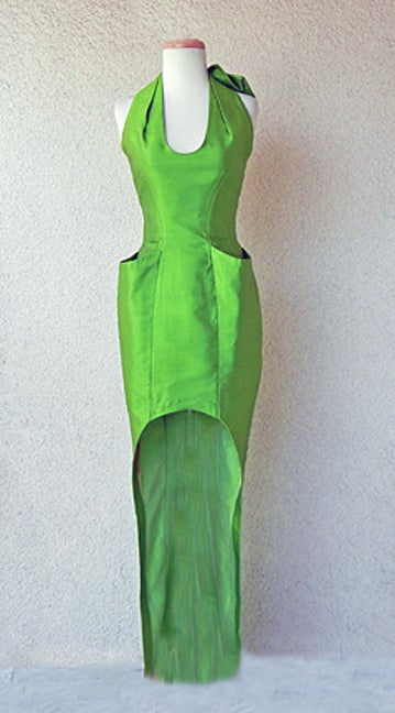 Circa 1980's Thierry Mugler rare kelly green shantung silk form fitting halter dress. Edgy hi fashion silhouette with strong lean lines; stylish hip pockets. Princess seaming; inverted scooped front designed to showcase your legs. Open back snap