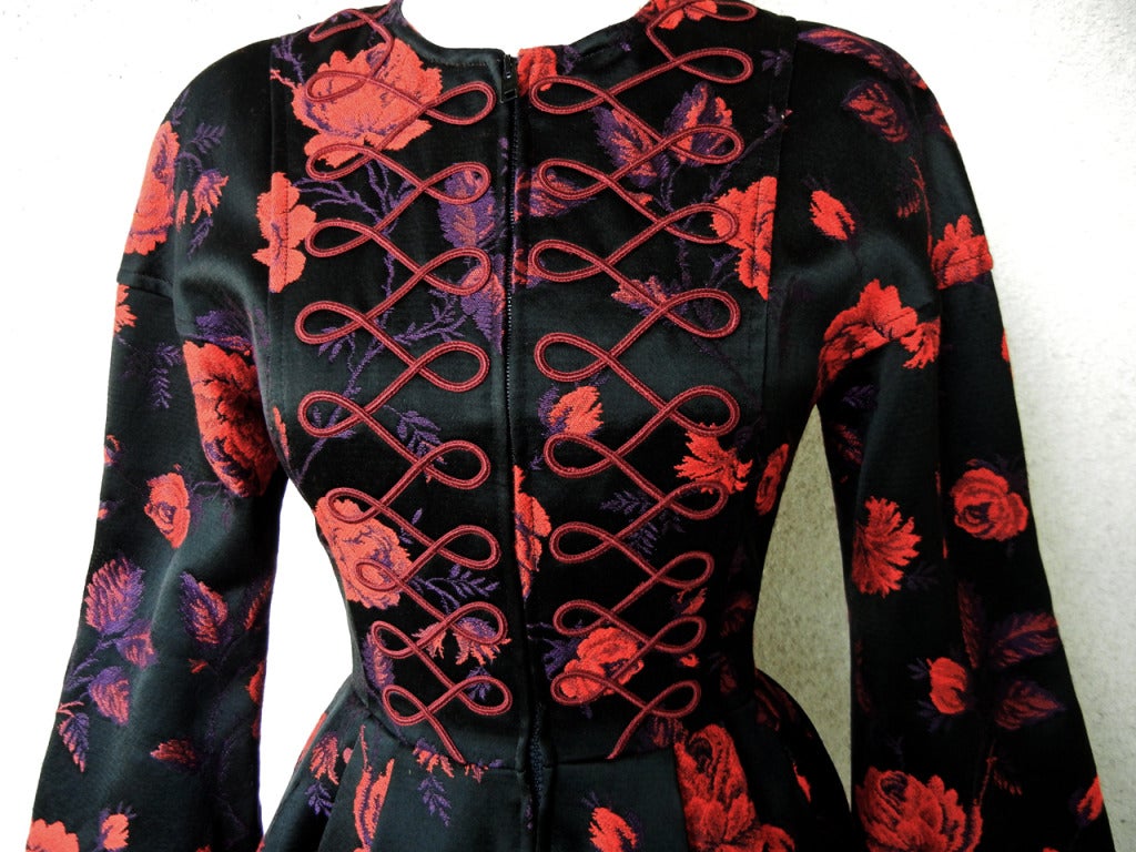 Circa  late 1980's Christian Lacroix mini dress coat.    Beautifully tailored very substantial and weighty piece with front zipper closure and elaborate pleating and tailoring.   

Fashioned of heavy silk, rayon floral brocade with bell sleeves,