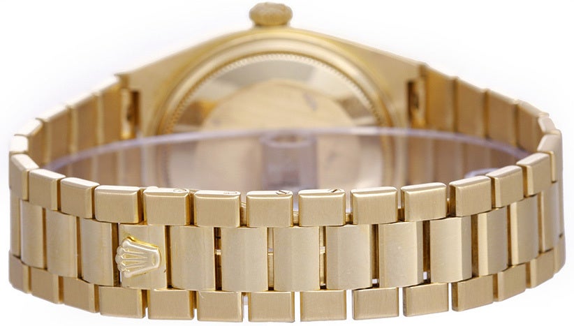 18k yellow gold case with fluted bezel. White dial with raised gold stick markers. 18k yellow gold hidden-clasp bracelet. Quartz movement; quick-set; sapphire crystal. Pre-owned with box and books.