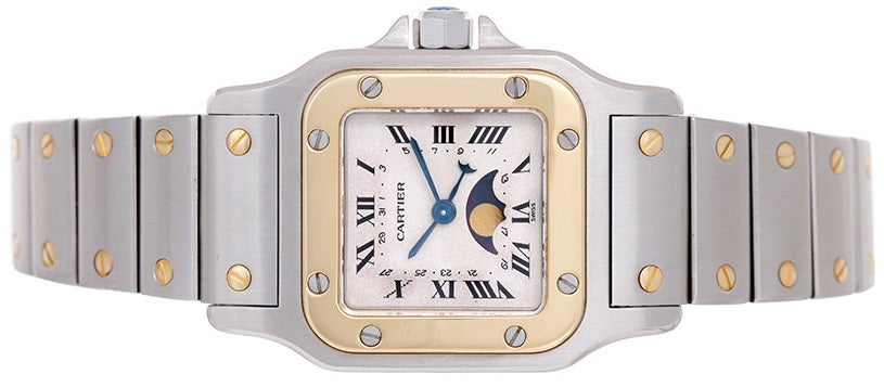Stainless steel case with 18k yellow gold bezel (24mm x 34mm). Ivory-colored dial with black Roman numerals and moonphase indicator. Stainless steel bracelet with gold screws. Quartz movement. Pre-owned with custom box.