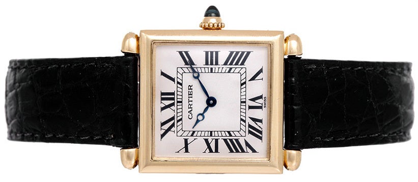 18k yellow gold case (25mm x 32mm). Ivory-colored dial with black Roman numerals. Cartier strap and 18k yellow gold buckle. Quartz movement. Pre-owned with box and papers.