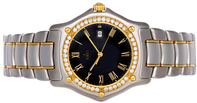 Ebel 1911 Stainless Steel, Gold and Diamond Midsize Wristwatch, Ref. 1087911, with quartz movement. Stainless steel case with 18k yellow gold and diamond bezel  (33mm diameter). Black dial with gold Roman numerals; date at 3 o'clock. Stainless steel