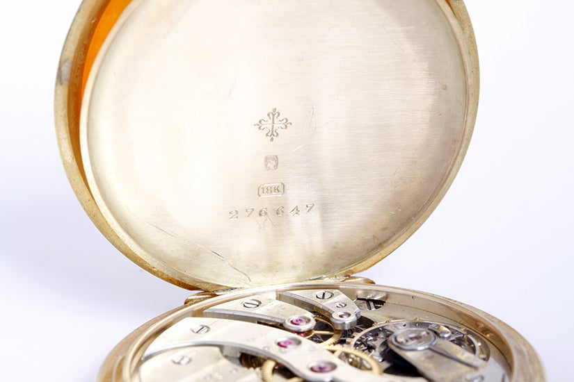 Patek Philippe 18k yellow gold 18-jewel pocket watch retailed by Tiffany & Co., with manual wind movement, 18 jewels. 18k yellow gold case with black enamel monogram on back and Greek key design around the bezel (minor enamel damage as shown in