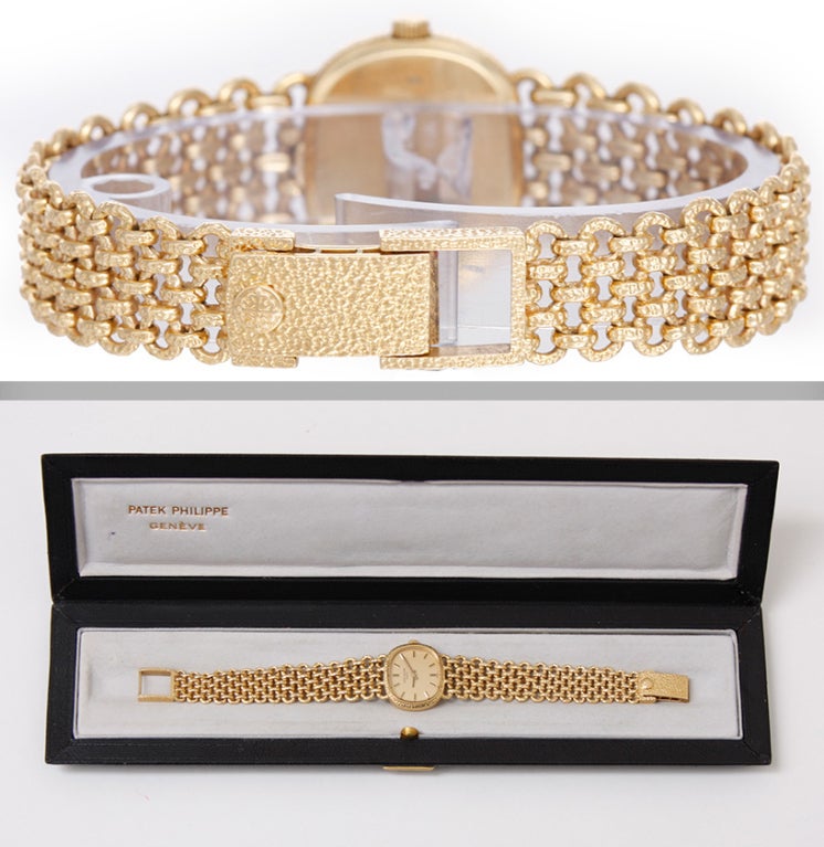Lady's Patek Philippe Ellipse bracelet watch, 18k yellow gold manual-wind, Ref. 41433/1. 18k yellow gold textured case (22m x 24mm). Gilt dial with gold baton markers. 18k yellow gold textured woven link Patek Philippe bracelet (will fit 6-1/4-inch