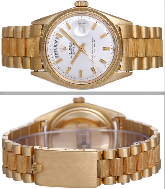 Rolex 18k yellow gold Day-Date Bark President wristwatch, Ref. 1807, with automatic movement. 26 jewels, acrylic crystal. 18k yellow gold case with barked bezel (36mm diameter). Silvered dial with gold baton markers. 18k yellow gold hidden-clasp