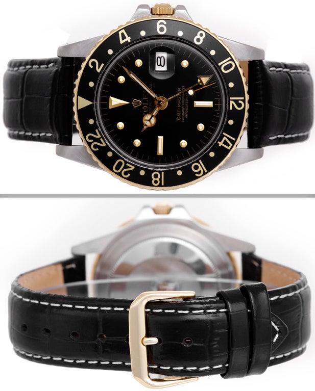 Rolex stainless steel GMT-Master wristwatch with gold bezel, Ref. 1675, with automatic movement. Stainless steel case, rotating gold bezel with black insert (40mm diameter). Black dial with gold markers. Back strap band with white stitching.