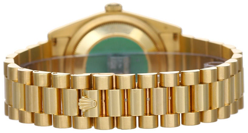 Rolex President Men's Watch 118238 - Automatic winding wristwatch. 18k yellow gold case with fluted bezel. Champagne dial with raised gold stick markers. 18k yellow gold hidden-clasp President bracelet. Pre-owned with box and books.