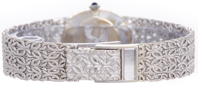 Baume & Mercier Lady's 18k white gold and diamond wristwatch with lapis dial and manual-wind movement. 18k white gold case with diamond bezel. Lapis blue dial. 18k white gold woven mesh bracelet (will fit 6-1/4-in. wrist). Pre-owned with box.