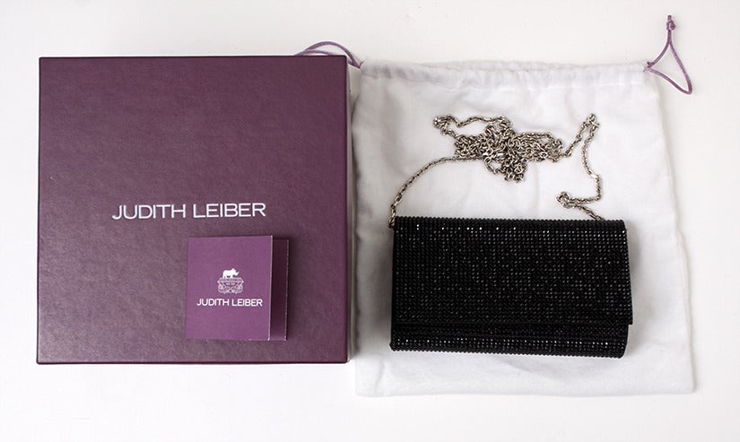 Signature Judith Leiber glamour on a soft-studded clutch.
•	
•	Fully beaded, soft-sided style.
•	Shoulder chain may be tucked in, 19