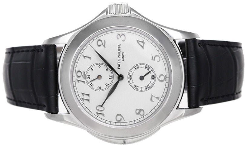 Automatic winding; dual time. 18k white gold case. White dial with white gold Arabic numerals. Strap band with 18k white gold Patek Philippe deployant clasp. Pre-owned with box and papers.