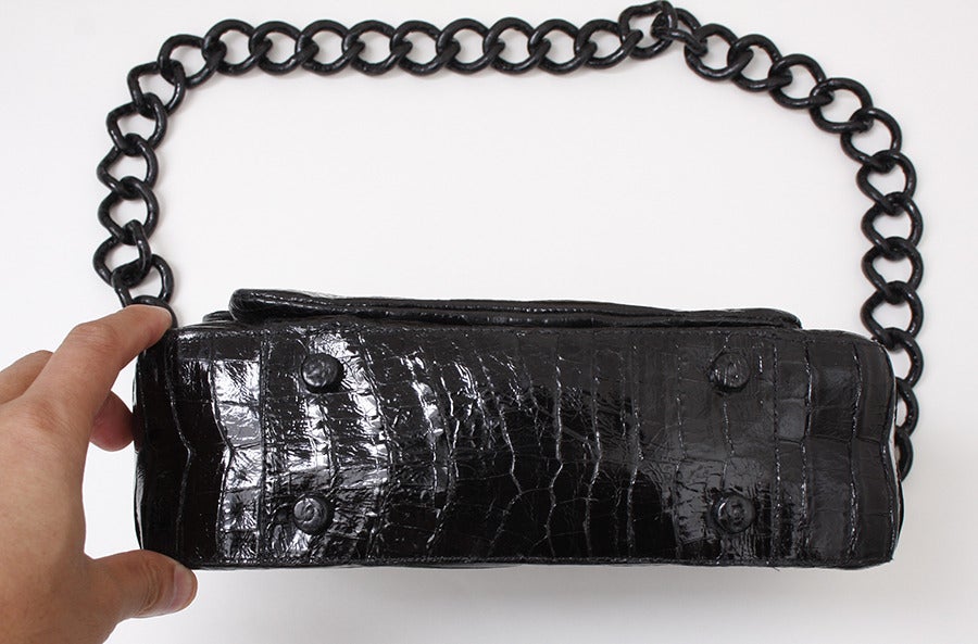 No detail goes overlooked: signature crocodile covers even the chain strap of this Nancy Gonzalez shoulder bag.Shiny Caiman fuscus crocodile.Self-covered chain shoulder strap, 14 inch drop Magnetic flap top; double-gusset sides.Inside, three open