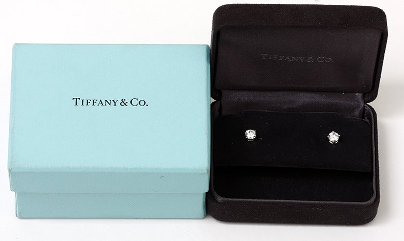 Beautiful Tiffany & Co. Diamond Solitaire Stud Earrings in Platinum - . Approximately .80 carat of sparkling Tiffany quality VVS E-F color diamonds. Pre-owned with Tiffany inner and outer boxes.
