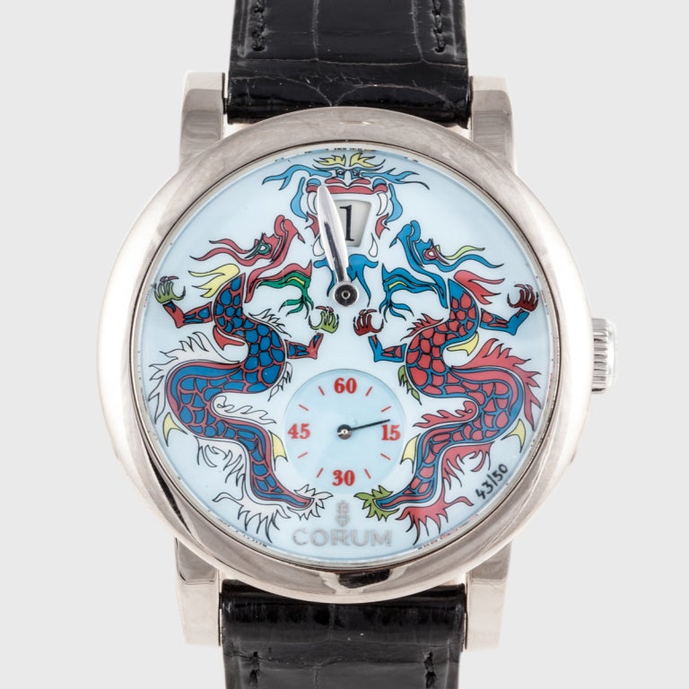 This Corum watch is a limited edition piece, signed 43/50. It features a double dragon design, and a jump hour movement. The case is 18k white gold.
