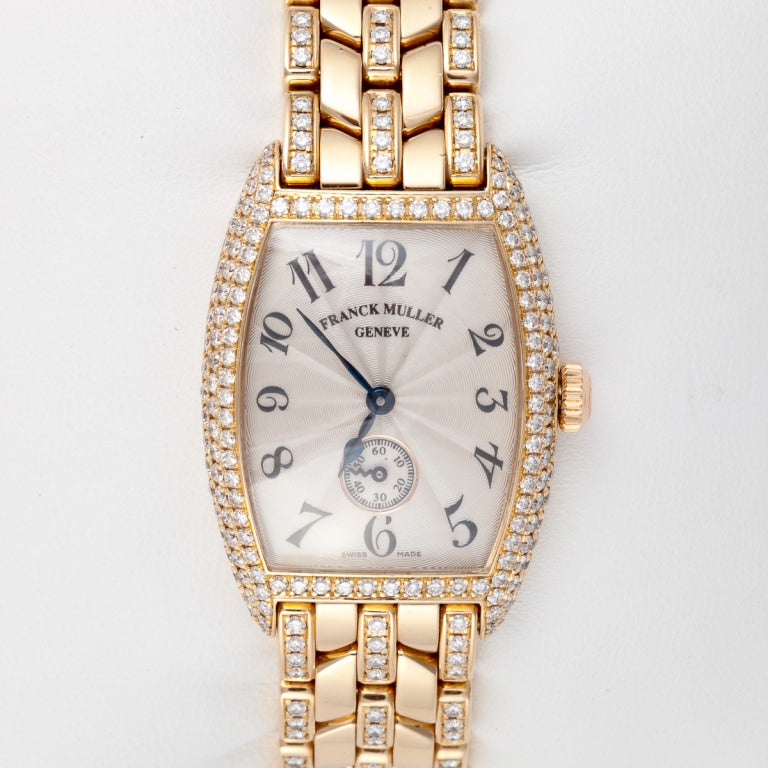 This lady's wristwatch is by Franck Muller, Curvex Chronographe, Model 1750S6PM.  It is 18K yellow gold with round diamonds that total 2.75 carats.  