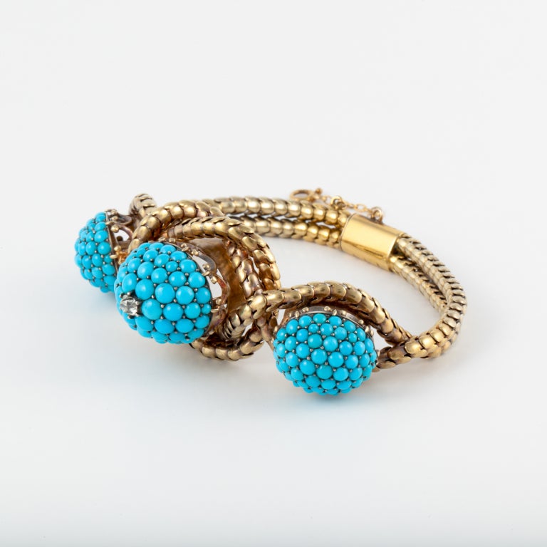 This antique bracelet by Garrard & Co. is 18K yellow gold with turquoise beads and one single diamond accent.  Circa 1860.  Accompanied by the original fitted box.