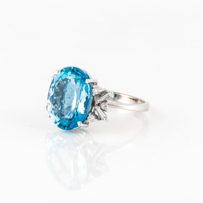 This H. Stern ring features an oval-cut aquamarine in the center that weighs approximately 8 carats. The ring also features 6 round diamonds and four baguette-cut diamonds that weigh .20 carats total weight. The mounting is 18kt white gold.