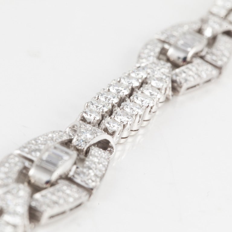 An estate bracelet in openwork platinum with diamonds, signed Birks.  It features full-cut, single-cut and baguette diamonds that total 11.50 carats total weight. It measures 7 inches in length.