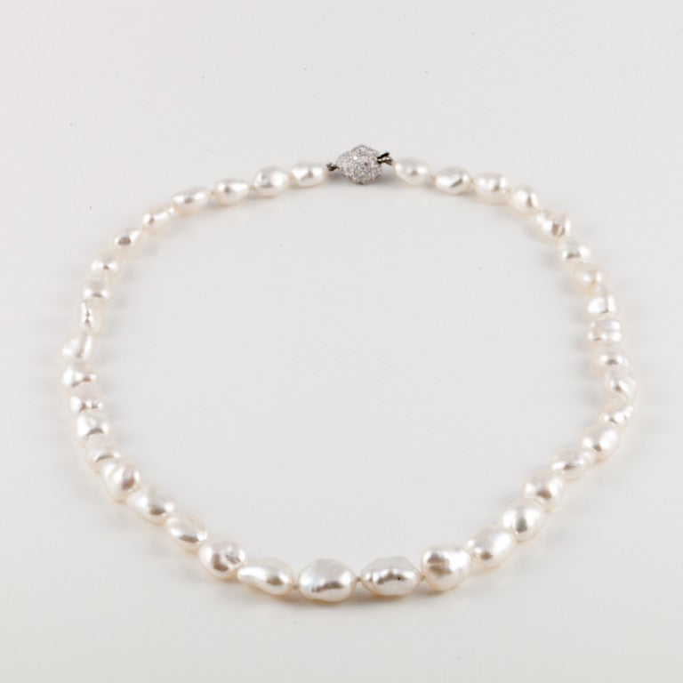 This necklace by Tiffany & Co. features 30 south seas cultured keshi pearls and a platinum clasp with 0.70 carats total weight of pave diamonds. The necklace is 17 inches in length.