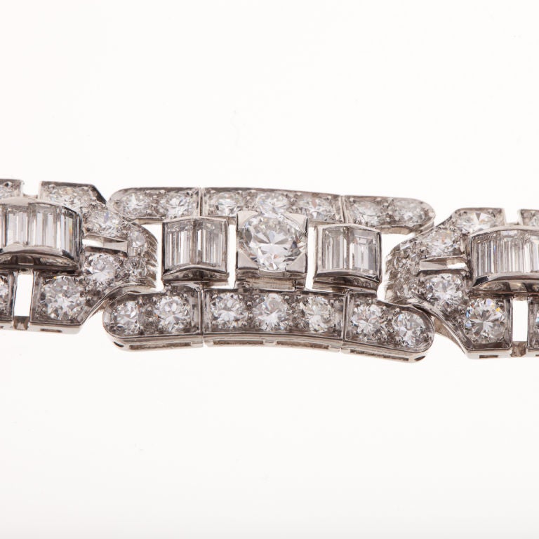 This Art Deco diamond bracelet by Tiffany & Co. is composed of platinum with old European cut round diamonds and baguette diamonds.  The diamonds total 12 carats, F-H color and VVS2-VS2 clarity.  This bracelet is a fine example of the Art Deco time