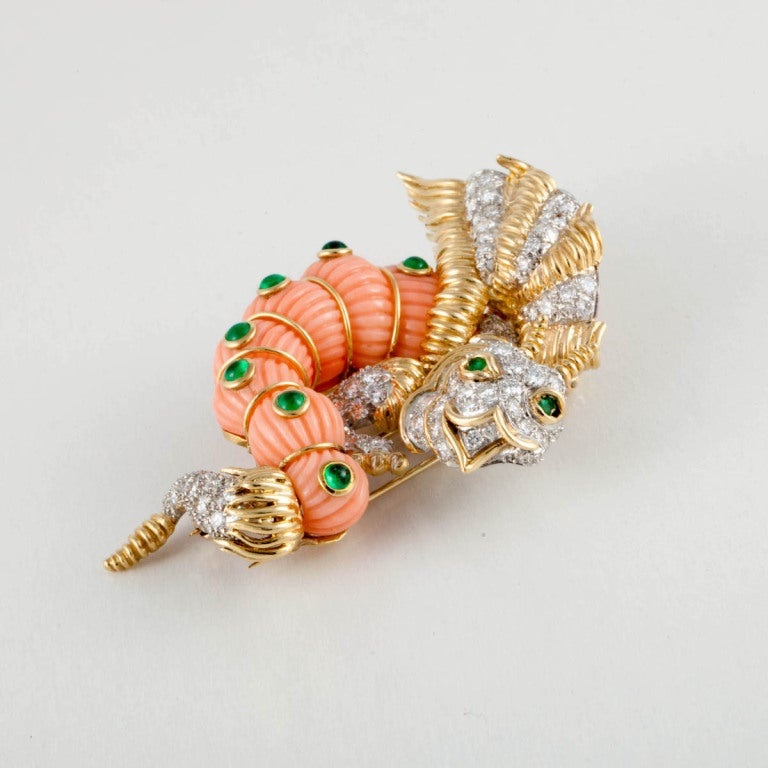 CARTIER 18KT yellow gold, platinum, diamond, coral, and cabochon emerald dragon pin.
Signed:  Cartier 18KT
