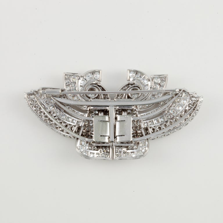 Art Deco platinum diamond dress clips that may convert to a brooch.  There are 238 round diamonds that total 12.50 carats,  E-H color and VVS2-VS2 clarity.