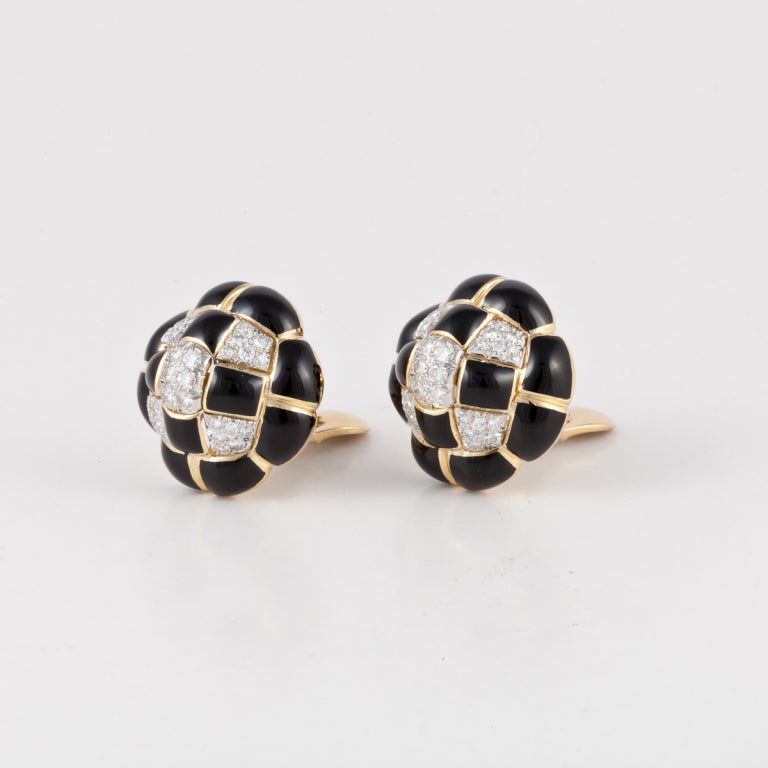 David Webb button style earrings composed of 18K yellow gold with black enamel accents and round brilliant cut diamonds set in platinum.  The diamonds total 2.05 carats, G-H color and VS clarity.  They are marked 