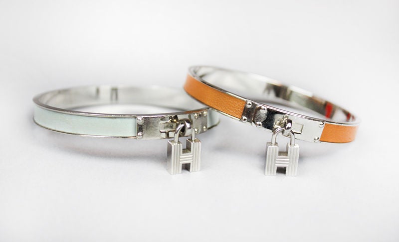 A collection of 5 enamel kelly bracelets by Hermes, plated in gold and silver and palladium. Two silver and enamel bracelets with 