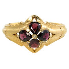 A beautiful gold, diamond and garnet bangle bracelet.