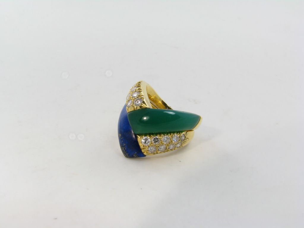 Two Van Cleef & Arpels rings.  Each ring is set in 18 karat yellow gold and diamonds.  One is set with  lapis lazuli the other with green onyx.  French.  Size 6 1/2.