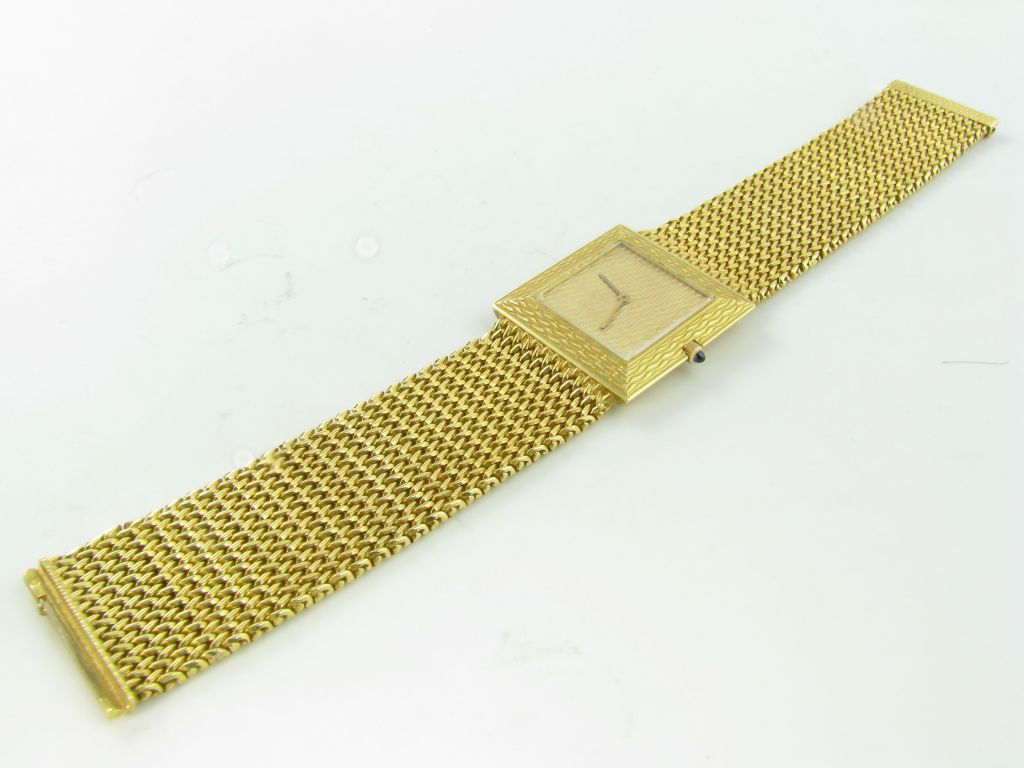 An 18k yellow gold wristwatch with woven bracelet and pattern to the dial and bezel. Boucheron, Paris.