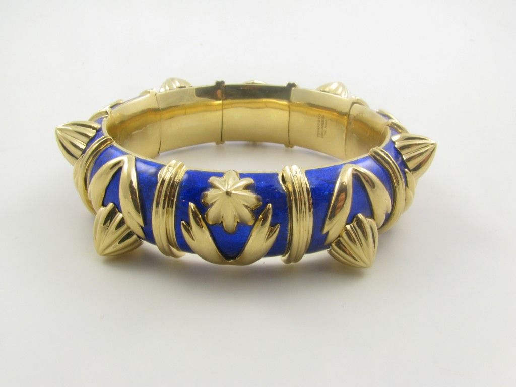 A gorgeous 18 karat yellow gold and cobalt blue paillonee enamel bangle bracelet.  Signed Tiffany, Schlumberger France.  The bracelet is from the 
