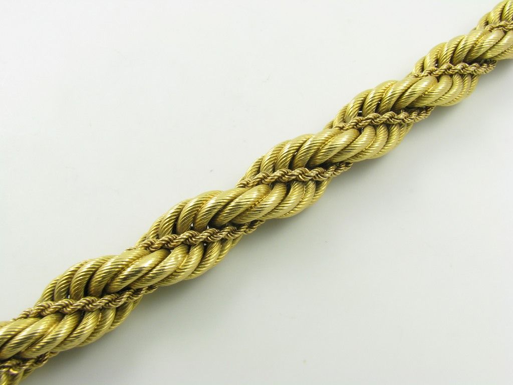 An 18 karat yellow gold bracelet.  Signed Tiffany and Company Italy.  The bracelet is designed as a double twisted rope with an approximate gross weight of 50.00 grams.