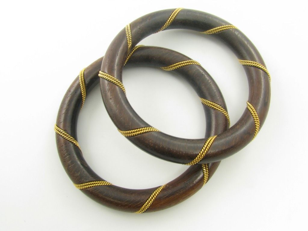 A fabulous pair of 18 karat yellow gold and wood bangles.