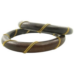 Vintage A fabulous pair of 18 karat yellow gold and wood bangles.