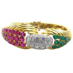 DAVID WEBB elegant gold, ruby, diamond and emerald bracelet.