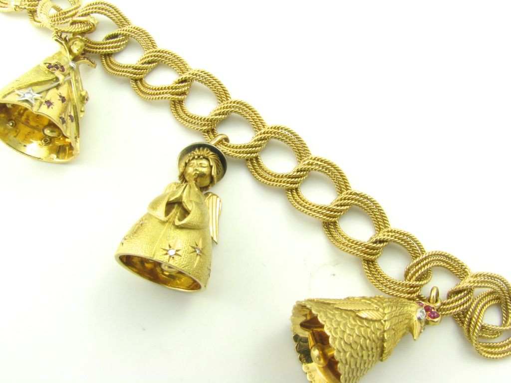 A one of a kind yellow gold, ruby and diamond charm bracelet.