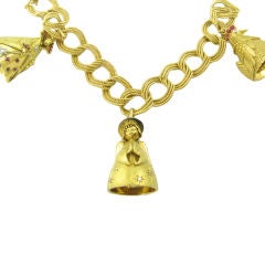 Retro A one of a kind yellow gold, ruby and diamond charm bracelet.