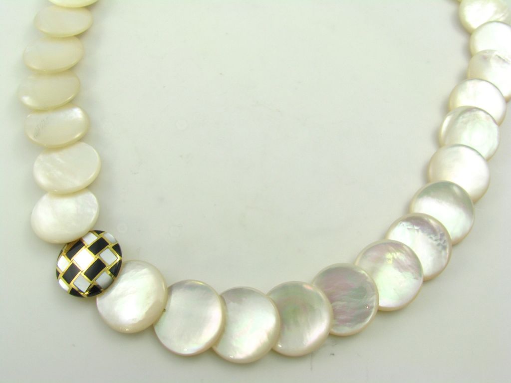 An 18 karat yellow gold, mother of pearl and onyx necklace.  Angela Cummings.