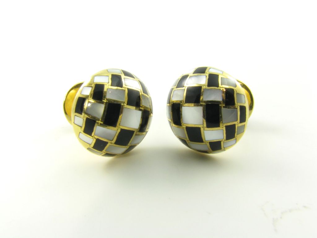 A pair of 18 karat yellow gold, mother of pearl and black onyx cuff links.  Signed Tiffany and Company.  Designed in checkerboard pattern with mother of pearl and black onyx.  Approximate weight of cufflinks is 13.3 grams.