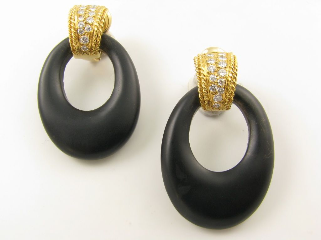 A pair of 18 karat yellow gold, diamond and ebony earrings. Signed VCA NY and numbered  3V509-4. The door knocker style earrings are set atop with a diamond and gold hoop style earring centering two rows of diamonds edged in twisted gold. The hoops