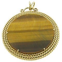 Vintage A  yellow gold and tiger's eye disc pendant set in twisted gold
