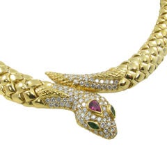 A gold, diamond, emerald and ruby nake necklace.