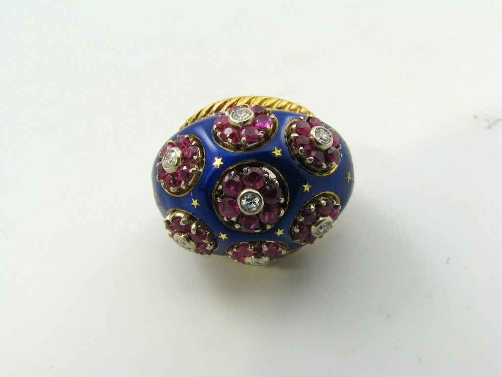 A stylish gold, enamel, ruby & diamond bombe style ring.