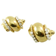 A chic pair of yellow gold and diamond shell earrings. A chic pair of yellow gold and diamond shell earrings.