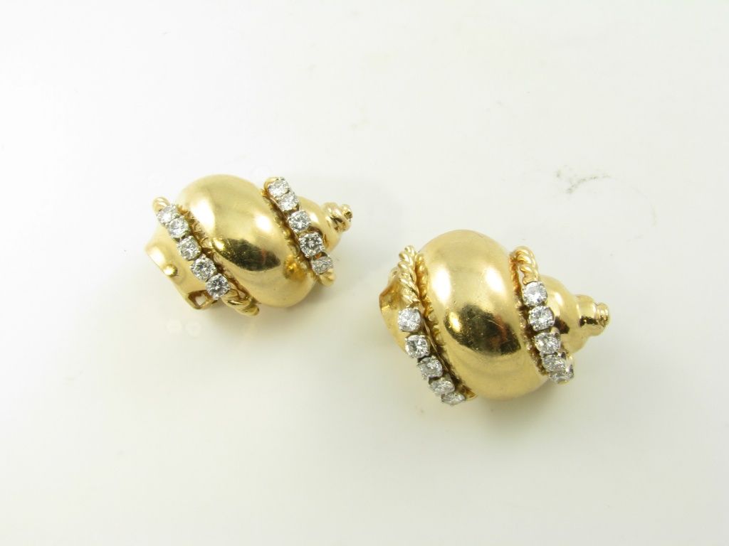 A chic pair of yellow gold and diamond shell earrings.