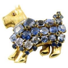 A whimsical yellow gold, sapphire, diamond 
ruby dog brooch.