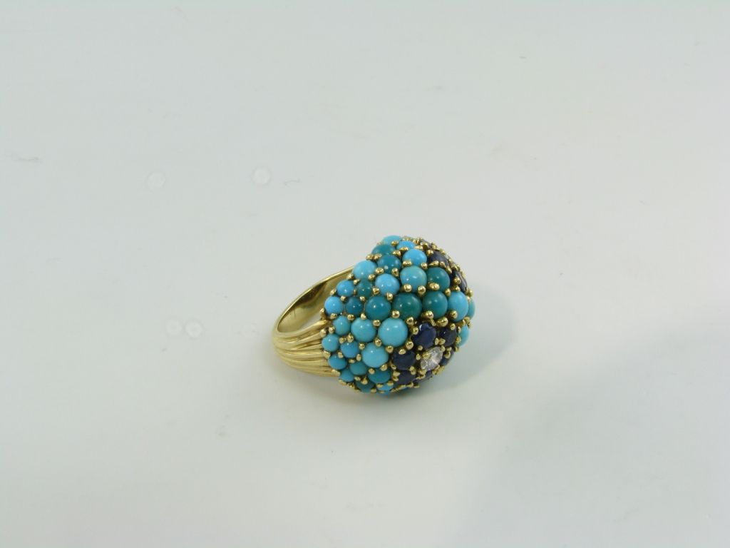 A stylish turquoise, sapphire, diamond and gold ring.