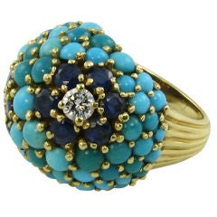 A stylish turquoise, sapphire, diamond and gold ring.